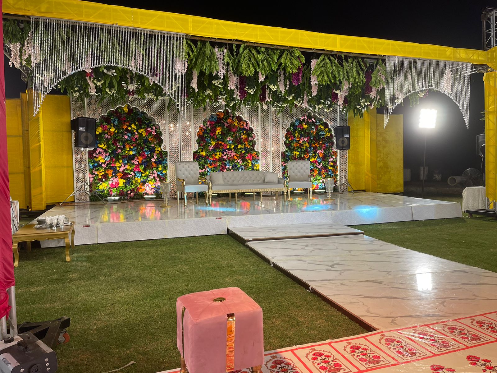 elevated couple stage with floral canopy and warm marquee lighting by Alvi Events & Catering in Lahore (36)