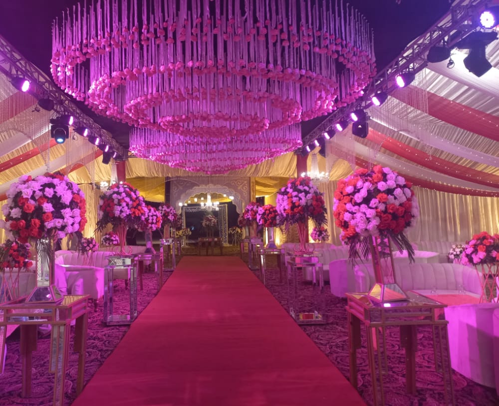 outdoor mehndi seating with floral arch and rainbow hanging tassels by Alvi Events & Catering in Lahore (47)