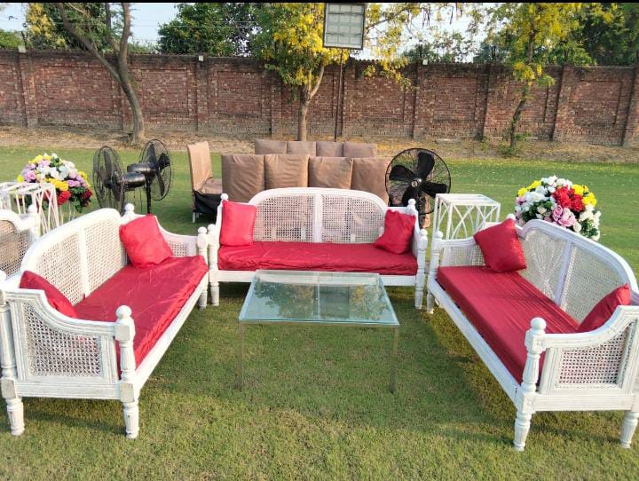 outdoor stage and seating under draped fabric and string lights by Alvi Events & Catering in Lahore (56)